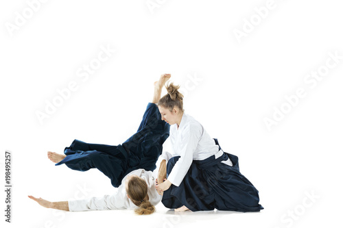 Man and woman fighting at Aikido training in martial arts school