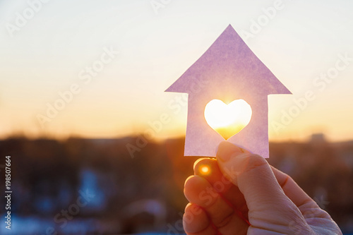 House with a carved heart on of sunrise.