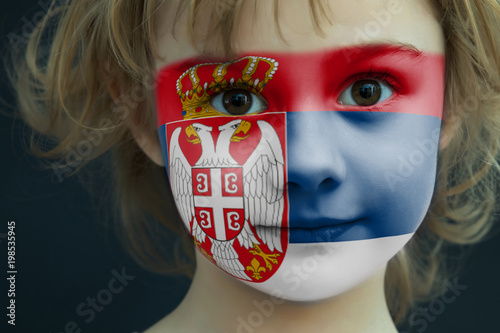 Portrait of a child with a painted Serbian flag
