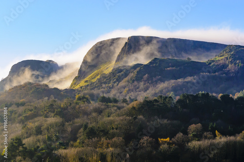 Mist/low clouds roll over "Napoleon's Nose", Cave Hill, Belfast in late autumn sunshine