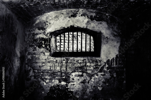 Window with a metal lattice in abandoned building