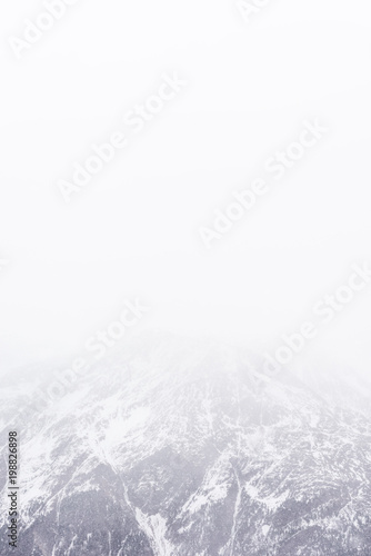 Snowfall in the Alps. Snow mountain and fog