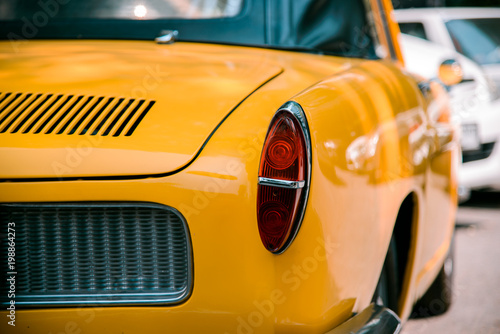 Close up taillight of Yellow retro classic car 