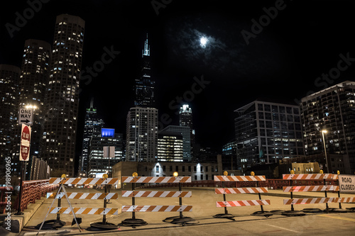 Closed Chicago city street bridge night scene with the Sears Willis Tower skyscraper and the moon