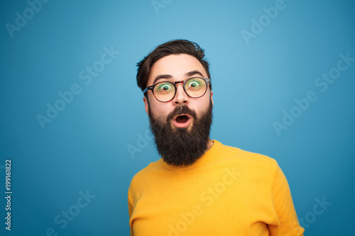 Super excited bearded hipster looking at camera