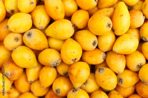 the fruits of loquat textured background, top view