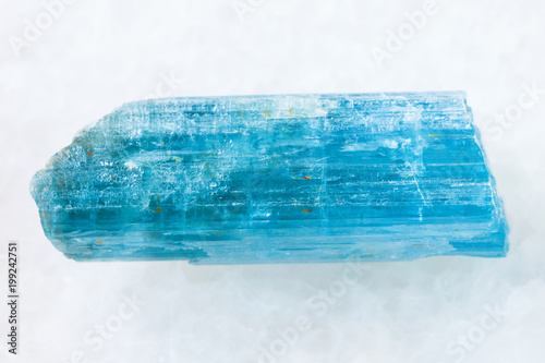 rough crystal of aquamarine (blue beryl) on white