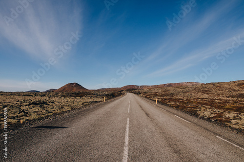 empty asphalt road in majestic icelandic landscape at sunny day, reykjanes, iceland
