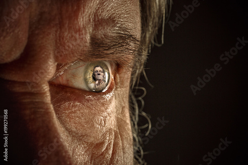 Half face of aggressive man looking with hatred into camera, domestic tyrant