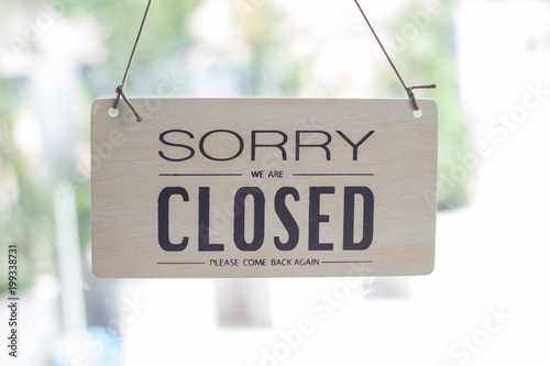 A sign hanging off Coffee shop door,Close sign blur background,Label word close