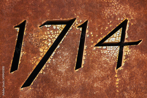 Year 1714 on rusty metallic surface