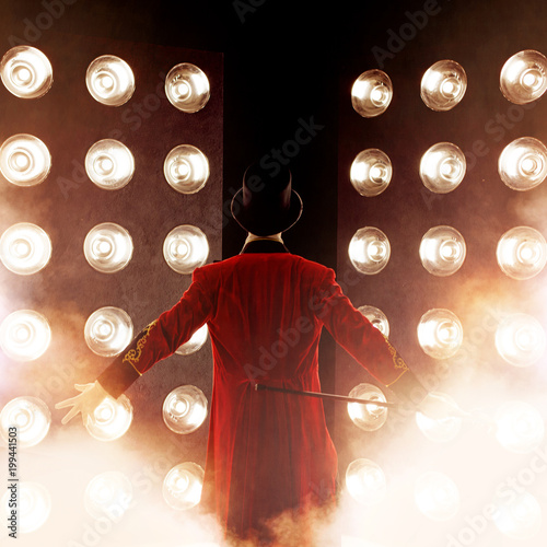 Showman Back, arms to sides. Young male entertainer, presenter or actor on stage. The guy in the red camisole