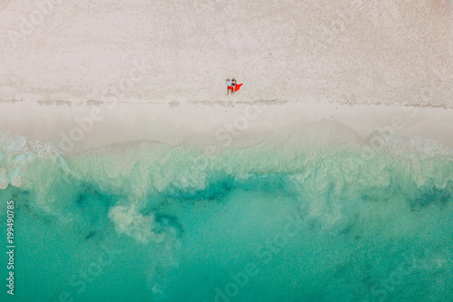 Drone photo. The couple lies on the beach