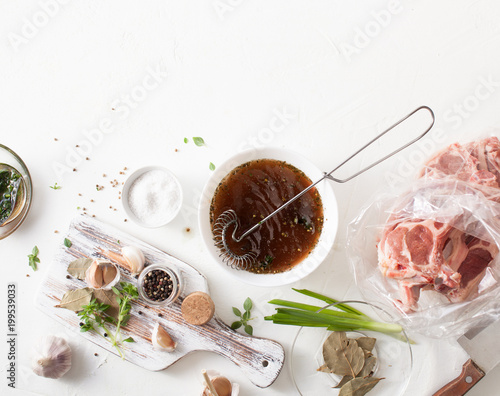 Cooking meat marinade on kitchen white table