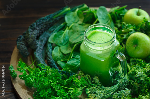 Variety of Organic Leafy Greens with a Glass Jar of Fresh Juice