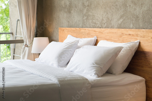 White pillows on the bed in loft style bedroom.