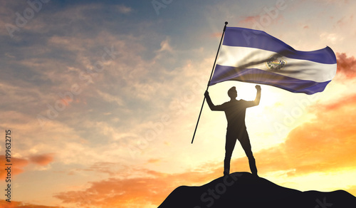 El Salvador flag being waved by a man celebrating success at the top of a mountain. 3D Rendering