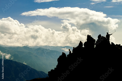 Silhouettes of tourists on a cliff of the Colca Canyon, in the province of Arequipa, Peru