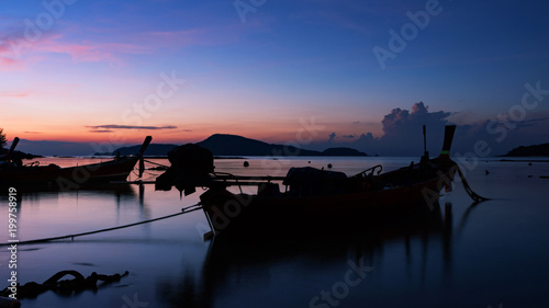 Longtail boat with coastal fishing village,Beautiful scenery view in morning sunrise over sea.