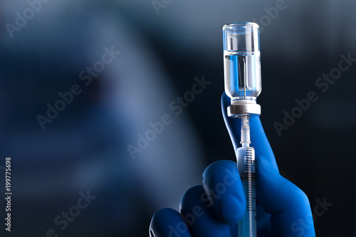 Doctor hand holds syringe and vaccine