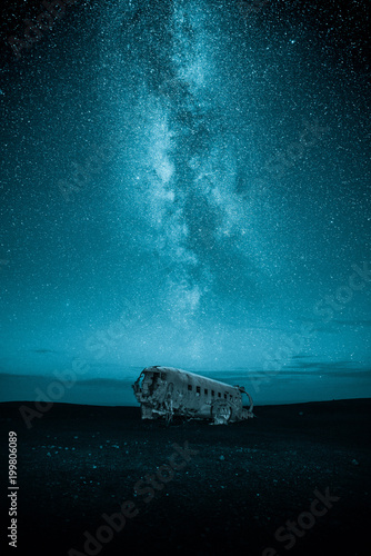 plane wreck at night with milky way on the sky