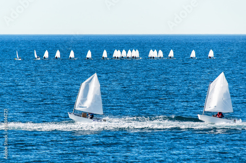 Optimist sailboat during a training