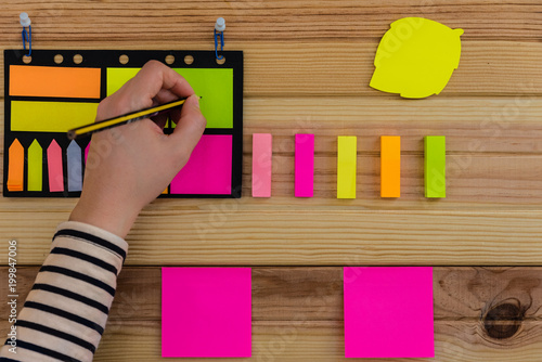 Note book and post-it notes on wooden background