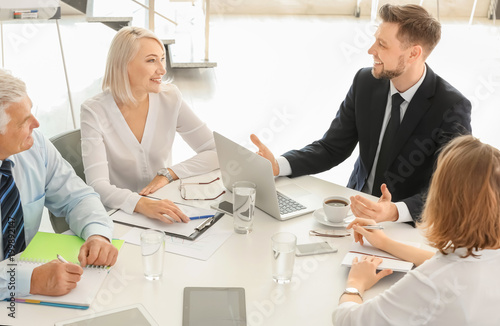 Group of people discussing ideas at table in office. Consulting service concept