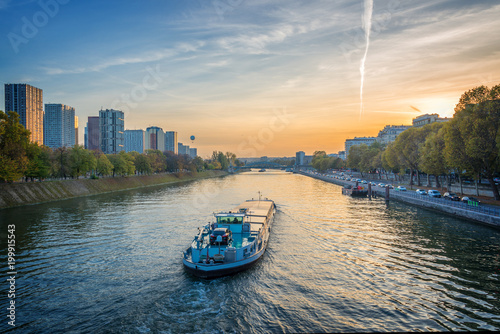 Barge on the river Seine at sunset, Paris France