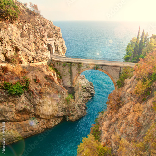 old bridge over fiord at sunset