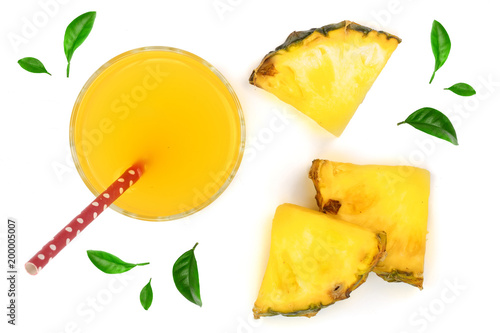 pineapple juice in a glass with pineapple slices decorated with green leaves isolated on white background. Top view