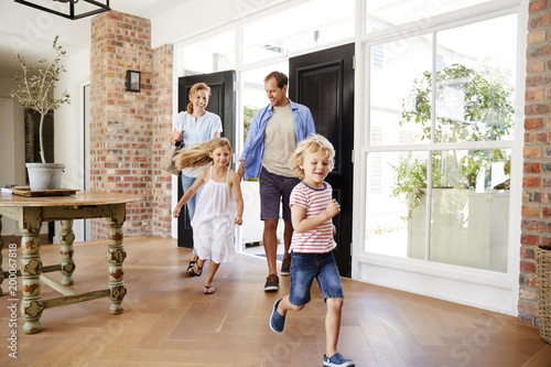 Young family arriving back to their home