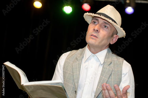 Man reading poetry on stage