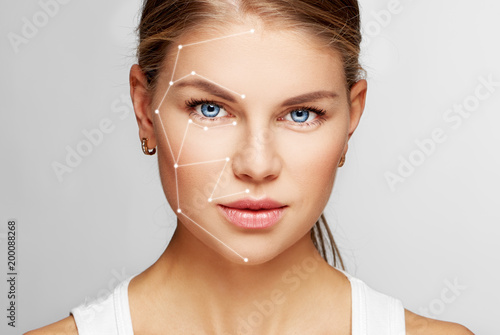 Skin care and technology. Portrait of beautiful woman face with drawn massage lines. 