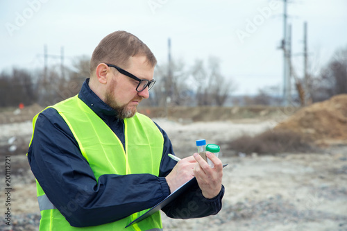 Adult man the ecologist. He studies the problems of ecology arising from the removal of construction debris and soil contamination.