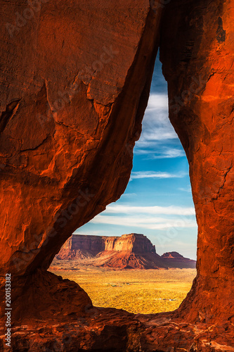 The Eagle Mesa seen through the Teardrop Arch in Monument Valley Navajo Tribal Park at sunset with beautiful and vibrant colors, Utah.