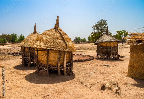 Traditional granaries made of woods and straw in an african village in Burkina Faso. They are on stilts to protect the crops against animals.