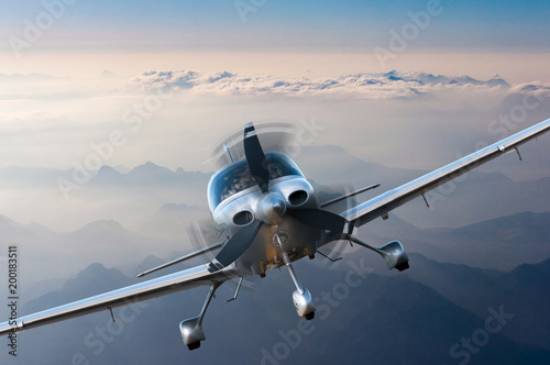 Privat light airplane or aircraft fly on mountain background. VIP travel concept