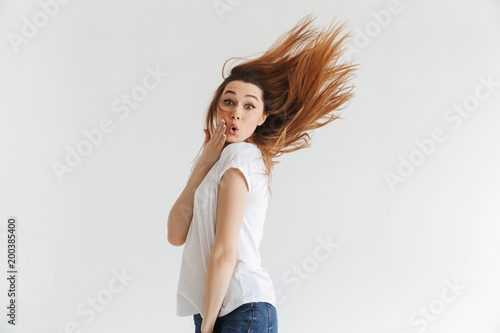 Side view of Surprised woman in t-shirt touchin her cheek