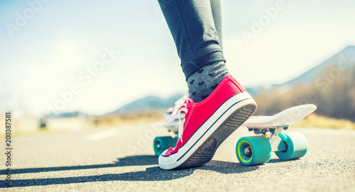 Close-up of girl's feet and penny board