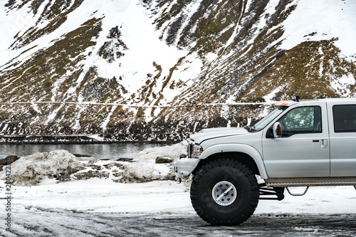 offroad car between snowy mountains