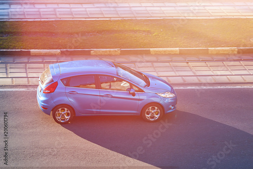 Blue passenger car in the sun