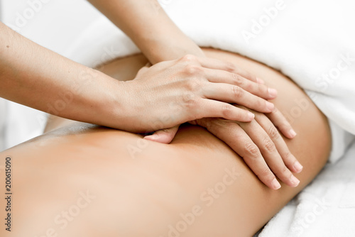 Young woman receiving a back massage in a spa center.