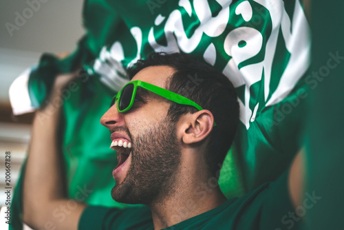 Saudi Arabia fan celebrating with flag