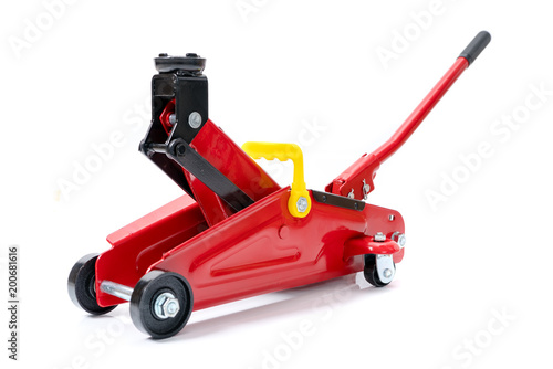 Red hydraulic floor jack isolated on white background