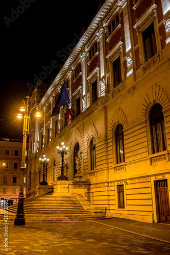 Vertical View of the Back Side of the Italian Parliament Building, Montecitorio, at Night Illuminated by Warm Lights. Rome, Italy