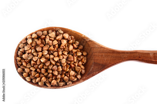 buckwheat in wooden spoon on white background. Isolate. Top view