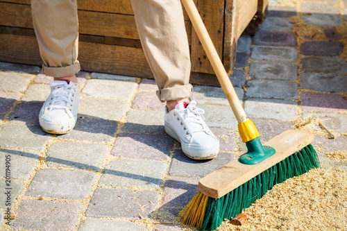 Woman with brush clean up yard