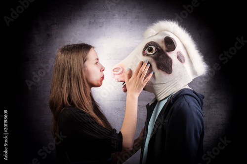 Girl and boy with horse head. Strange couple concept.