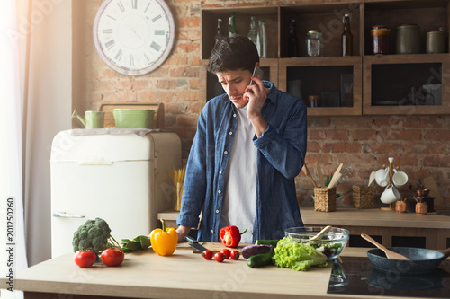 Upset man preparing healthy food in the home kitchen